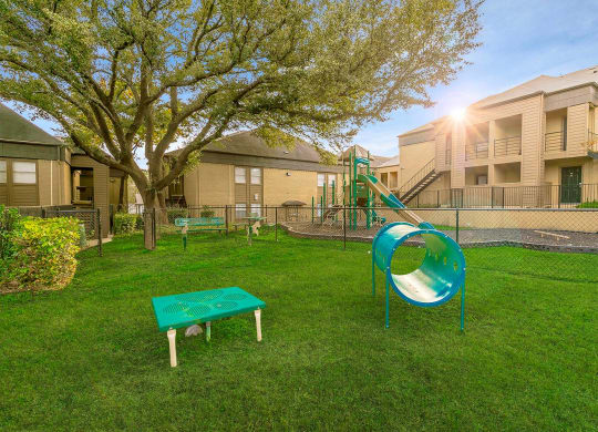 our apartments showcase a dog park with a playground