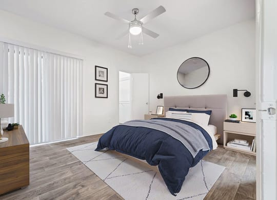 a bedroom with a bed and a ceiling fan