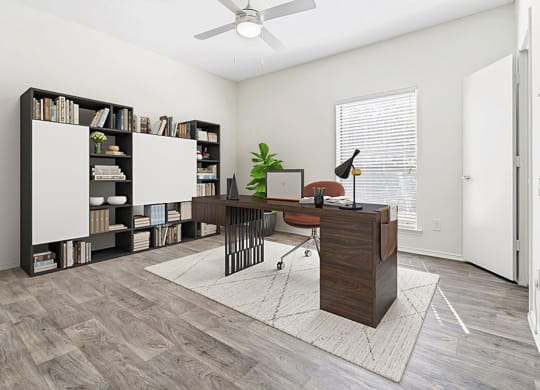 an office with a large window and a desk with a computer