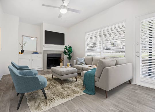 a living room with couches and chairs and a television
