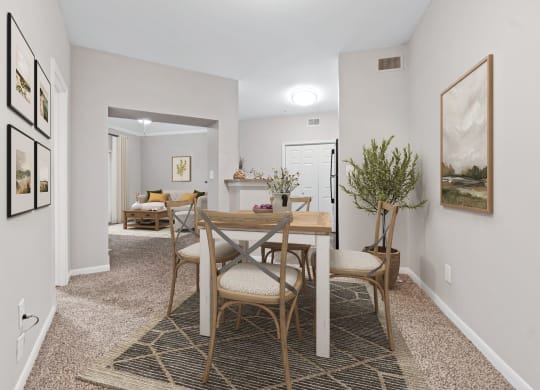 a dining room with a wooden table and chairs at Fountains of Denton in Denton, TX