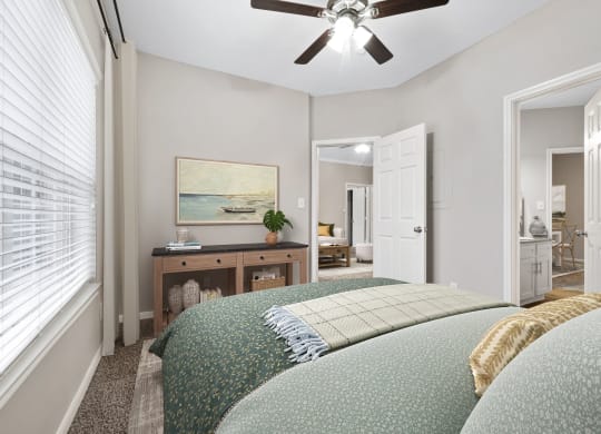 a bedroom with a large bed and a ceiling fan at Fountains of Denton in Denton, TX