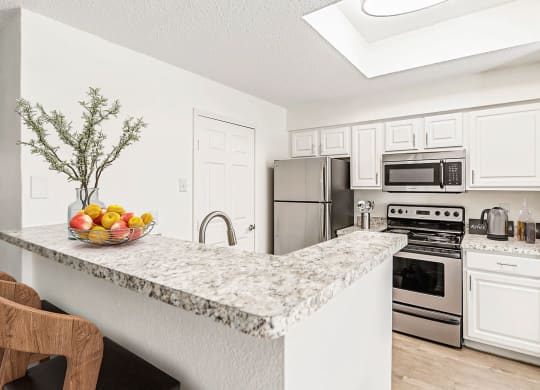 a kitchen with stainless steel appliances and a granite counter top