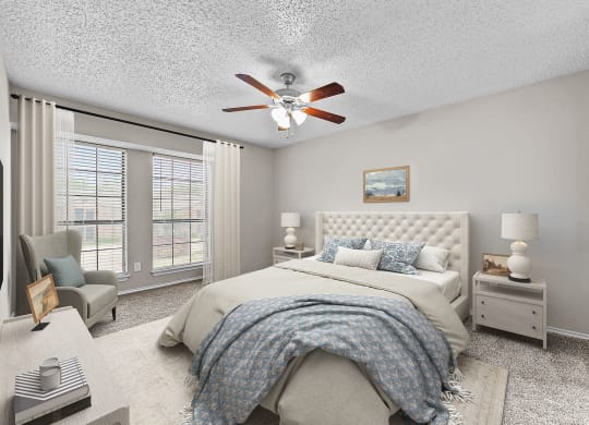 a bedroom with a large bed and a ceiling fan