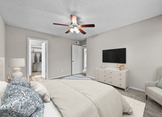 a bedroom with a large bed and a ceiling fan