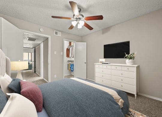 a bedroom with a bed and a ceiling fan