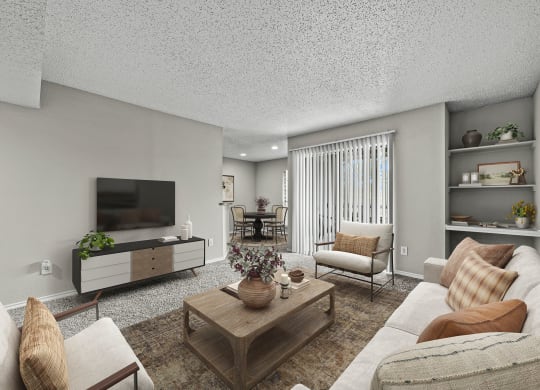 Living room with furniture and a television at Legacy Apartments in Plano, TX