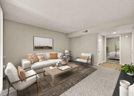 the living room of an apartment with a couch and a table at Legacy Apartments in Plano, TX