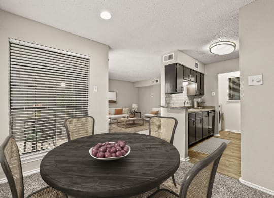 a dining room table with a bowl of fruit on it at Legacy Apartments in Plano, TX