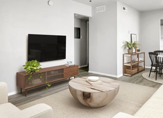 a living room with a large tv on the wall and a coffee table in the middle of  at Sunset Heights, Texas