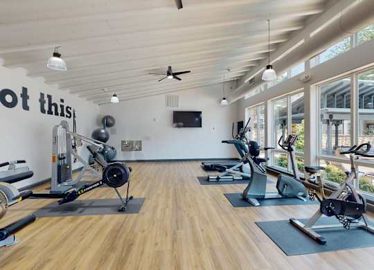 a gym with exercise machines and a tv  at Remington Ranch, San Antonio, TX