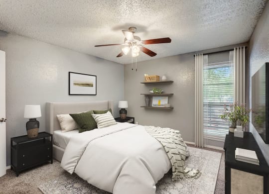 our apartments offer a bedroom with a large bed and a ceiling fan