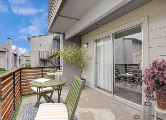 a patio with a table and chairs and a sliding glass door