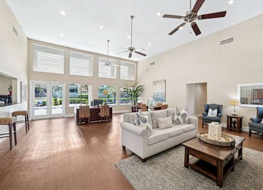 A living room with a white couch and a coffee table.