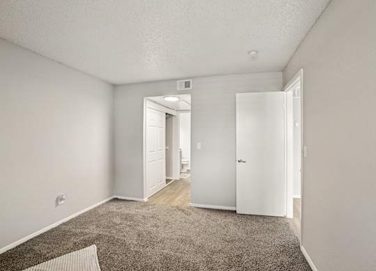 A room with a carpeted floor and white walls.