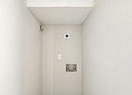 A white wall with a switch and a socket.