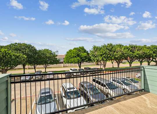 A parking lot with cars and trees.