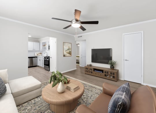 a living room with a ceiling fan and a coffee table in the middle of the room  at Sunset Heights, Texas, 78209
