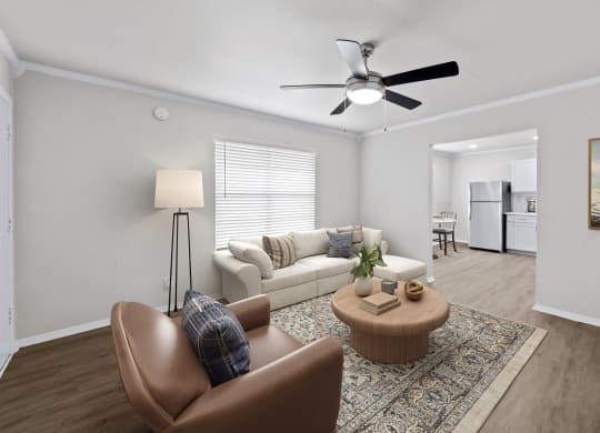 a living room with a couch coffee table and a ceiling fan  at Sunset Heights, Texas