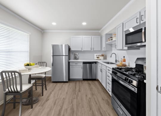 a kitchen with white cabinetry and stainless steel appliances  at Sunset Heights, San Antonio, TX, 78209