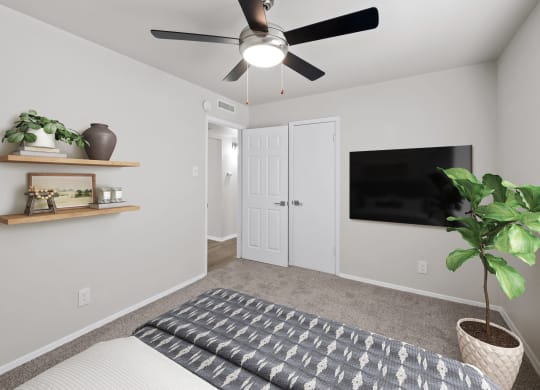 a bedroom with a ceiling fan and a tv on the wall  at Sunset Heights, San Antonio, TX