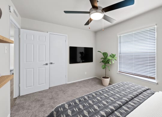 a bedroom with a ceiling fan and a window with a blind  at Sunset Heights, Texas, 78209