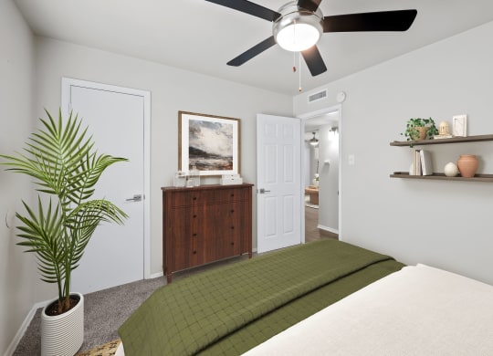 a bedroom with a bed and a ceiling fan  at Sunset Heights, San Antonio