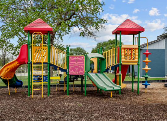 a colorful playground with slides and climbers  at Sunset Heights, Texas