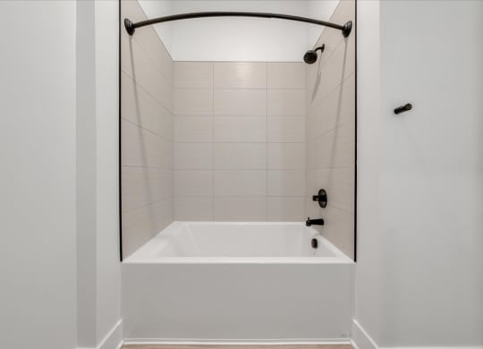 a bathroom with a tub and a shower curtain