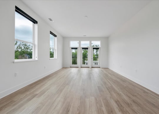 a bedroom with hardwood floors and white walls at Luxe 360 in Midlothian, Midlothian, 23114