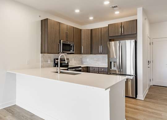 A modern kitchen with a white countertop and stainless steel appliances at Upper Vue Flats, Dublin