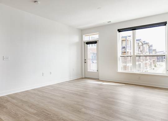 A large empty room with a view of a cityscape through the window at Upper Vue Flats, Dublin