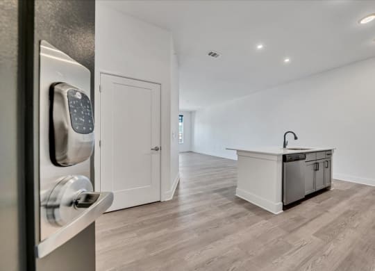 a white kitchen with a counter and a door with a door handle at Luxe 360 on Centerpointe Apartments, Midlothian, VA
