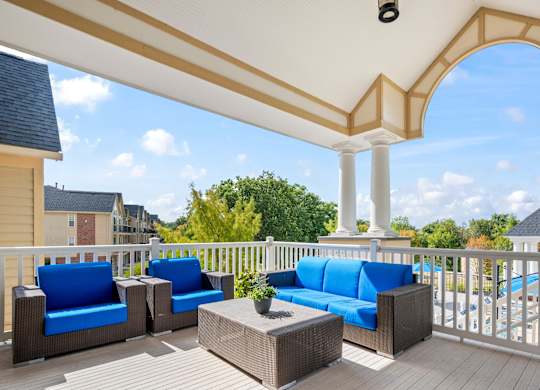 A patio with blue cushions and a white railingk at Timberlane Apartments, Peoria, Illinois