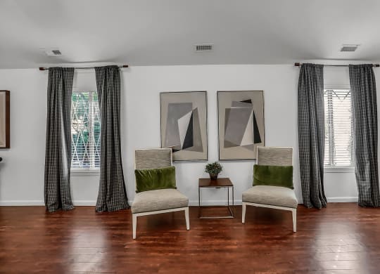 a living room with two chairs and two paintings on the wall at Polo Run Apartments, Indiana, 46142