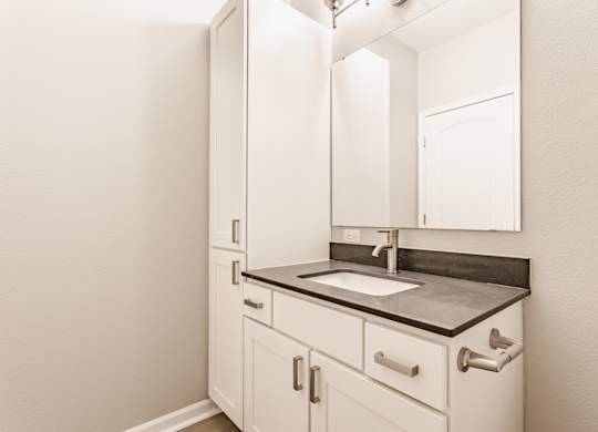 A bathroom with a sink and a mirror.