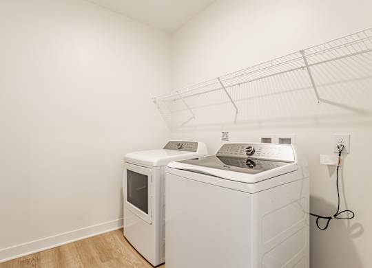 A white dryer and washing machine in a laundry room at Upper Vue Flats, Dublin