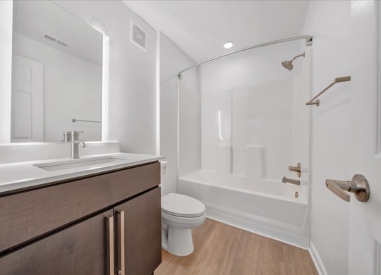 a bathroom with a sink toilet and a shower at The Vinings Apartments, Richmond