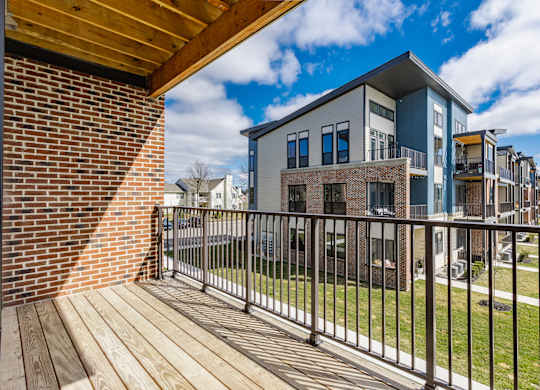 A modern building with a balcony overlooking a grassy area at Upper Vue Flats, Dublin