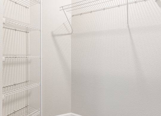 A white refrigerator with empty shelves.