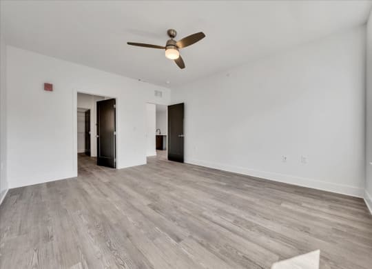 a living room with white walls and a ceiling fan at Luxe 360 on Centerpointe Apartments, Virginia