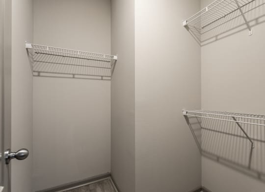 a walk in closet with two white closets and a door at Bella Vista Apartments, Fishers