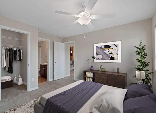 A bedroom with a bed, dresser, and closet.