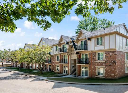 A large brick building with a white trim and a balcony on the second floork at Timberlane Apartments, Peoria, Illinois