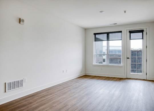 A room with a sliding glass door and a window.