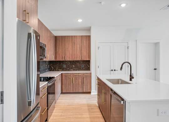 A modern kitchen with wooden cabinets and stainless steel appliances.