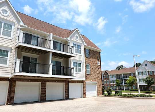 A two-story apartment building with a balcony on the second floor.