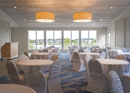 a large room with tables and chairs and a podiumat The Harbours Apartments, Michigan