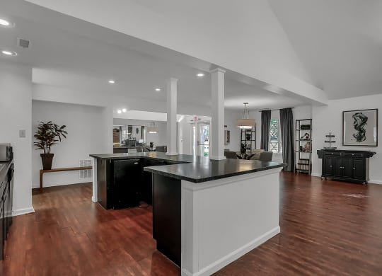 an open kitchen and lounge room with a large counter top in Greenwood Apartments clubhouse at Polo Run Apartments, Indiana