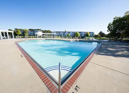 A large swimming pool with a red brick border at The Landings Apartments, Westland